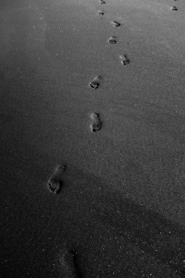 grayscale-photo-of-footprints-on-sand-3646206
